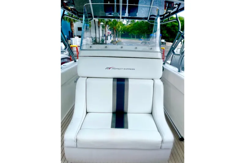 Slide: The Image of 2013 Midnight Express 39S Open boat seat with sleek white and black design. - 9