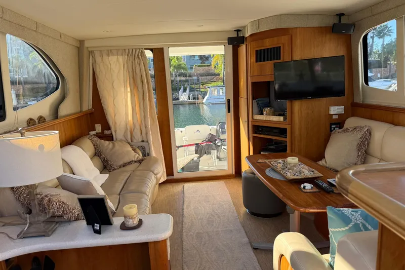 Slide: The Image of Luxurious interior of a 2003 Silverton 38 Convertible yacht with cozy seating and elegant decor. - 10