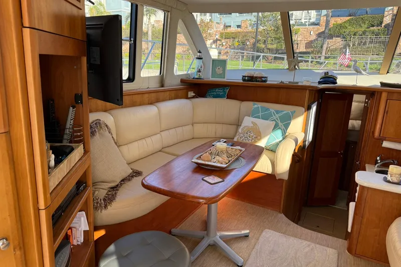 Slide: The Image of Luxurious interior of a 2003 Silverton 38 Convertible yacht with cozy seating and decor. - 14