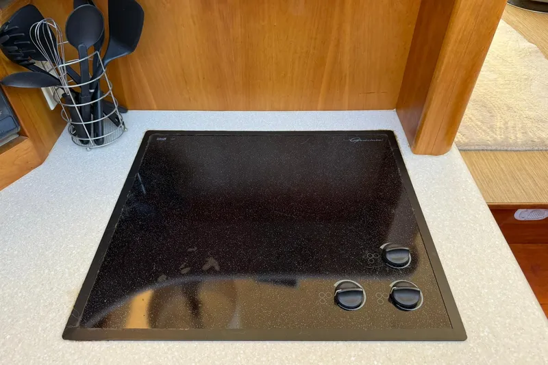 Slide: The Image of Stovetop in 2003 Silverton 38 Convertible yacht kitchen with utensils. - 20