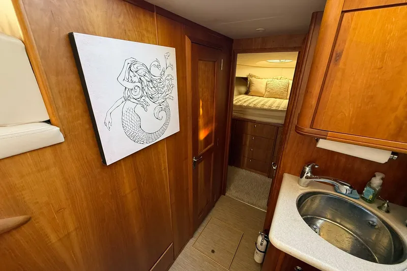 Slide: The Image of Interior of 2003 Silverton 38 Convertible yacht with mermaid artwork and cozy cabin. - 21