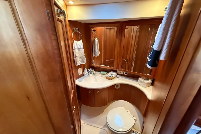 Slide: The Image of Luxurious bathroom in 2003 Silverton 38 Convertible yacht with wood accents and modern fixtures. - 22