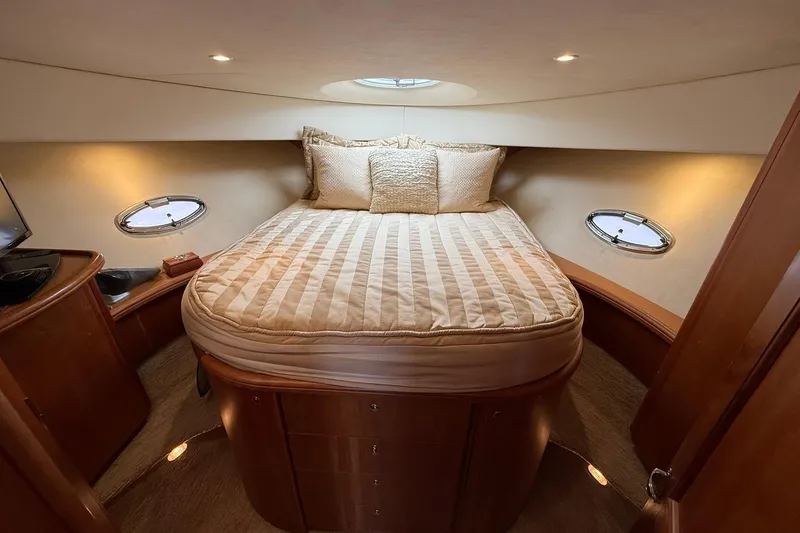 Slide: The Image of Luxurious cabin interior of 2003 Silverton 38 Convertible yacht with cozy bed and portholes. - 26