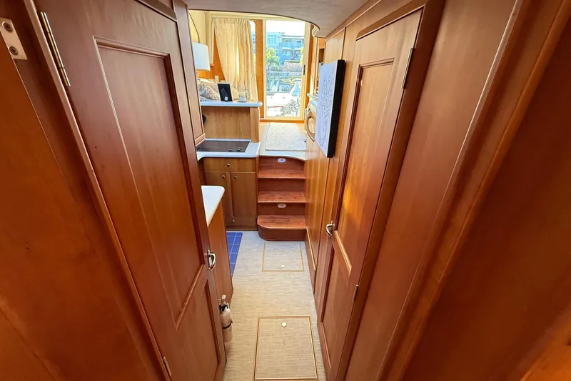 Slide: The Image of Interior of 2003 Silverton 38 Convertible yacht with wooden cabinetry and compact kitchen area. - 28