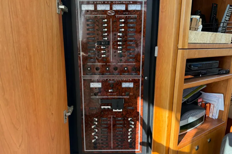 Slide: The Image of Electrical control panel on a 2003 Silverton 38 Convertible boat, featuring 12V DC and 240V AC controls. - 29