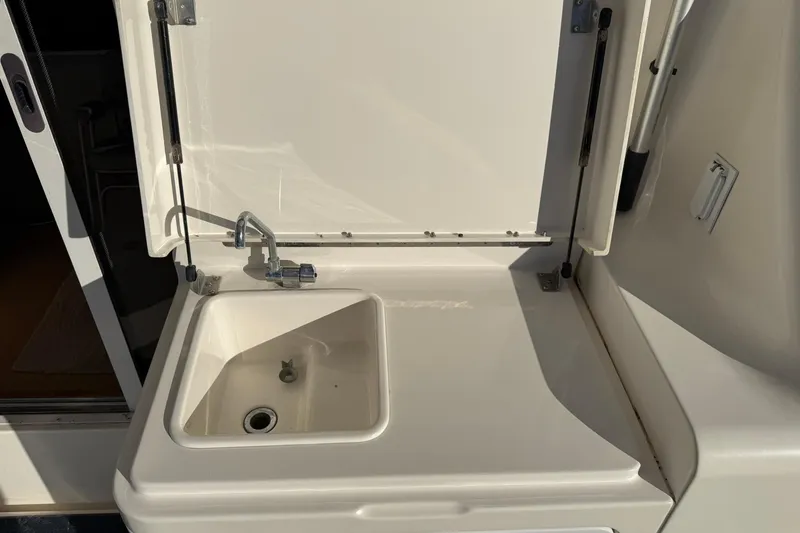 Slide: The Image of 2003 Silverton 38 Convertible yacht sink with closed lid and faucet. - 31