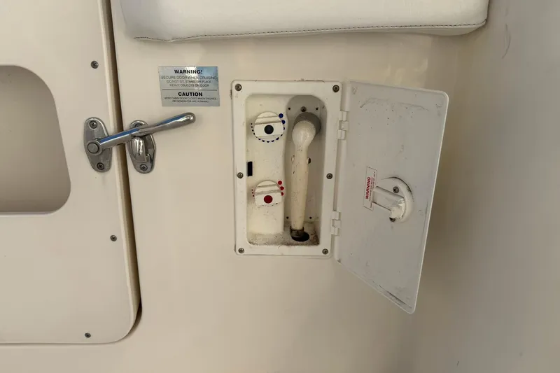 Slide: The Image of 2003 Silverton 38 Convertible boat shower compartment with handle and warning labels. - 34