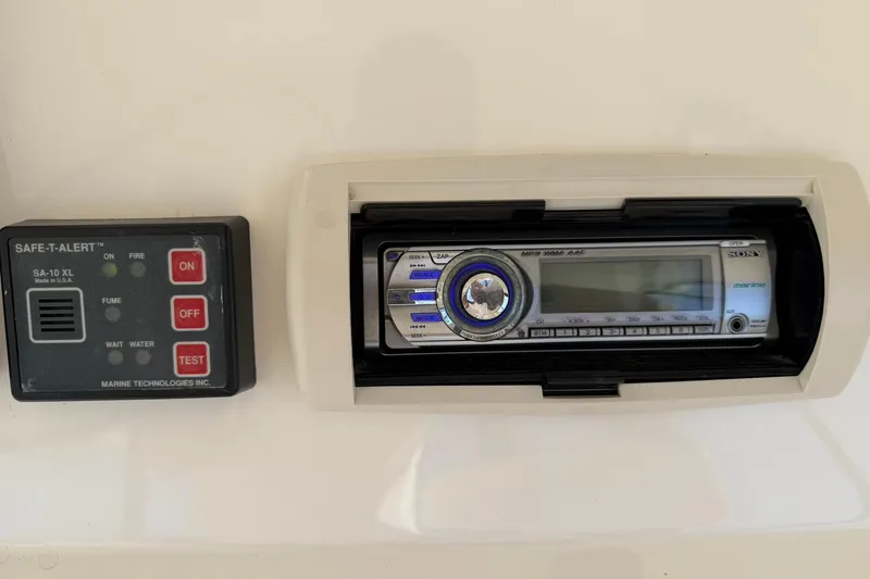 Slide: The Image of Control panel and stereo system on 2003 Silverton 38 Convertible boat dashboard. - 42