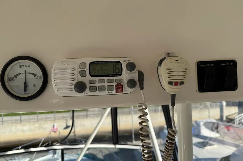 Slide: The Image of 2003 Silverton 38 Convertible boat dashboard with radio and control panel. - 43