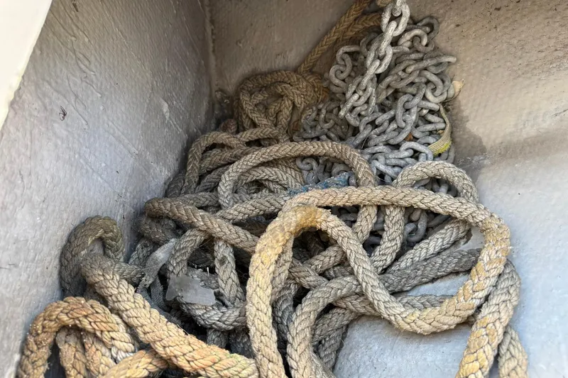 Slide: The Image of Tangled ropes and chains in a 2003 Silverton 38 Convertible boat compartment. - 45