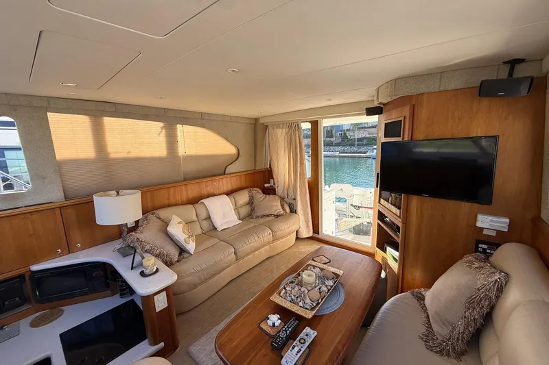 Slide: The Image of Luxurious interior of a 2003 Silverton 38 Convertible yacht with cozy seating and waterfront view. - 9
