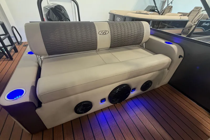 Slide: The Image of 2026 Bentley Pontoons Elite 223 Swingback with luxurious seating and ambient blue lighting. - 10