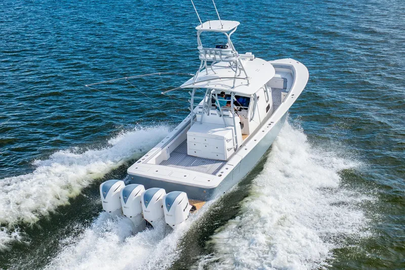 The Image of 2018 Regulator 41 boat cruising on open water with four powerful engines. - 0