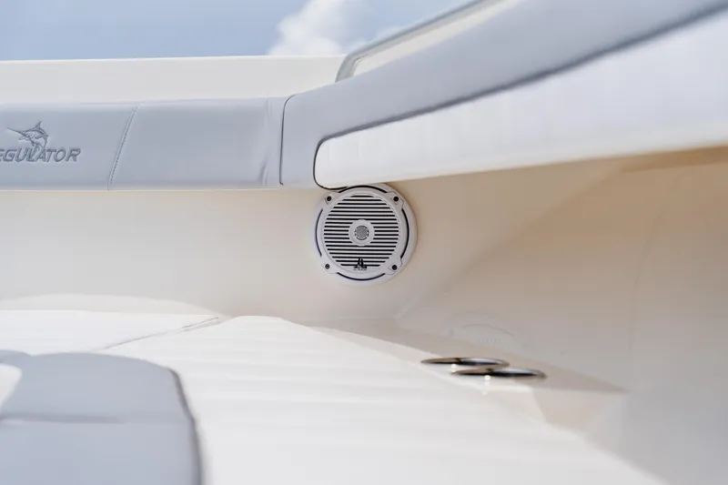 Slide: The Image of 2018 Regulator 41 boat interior with speaker and cushioned seating. - 101