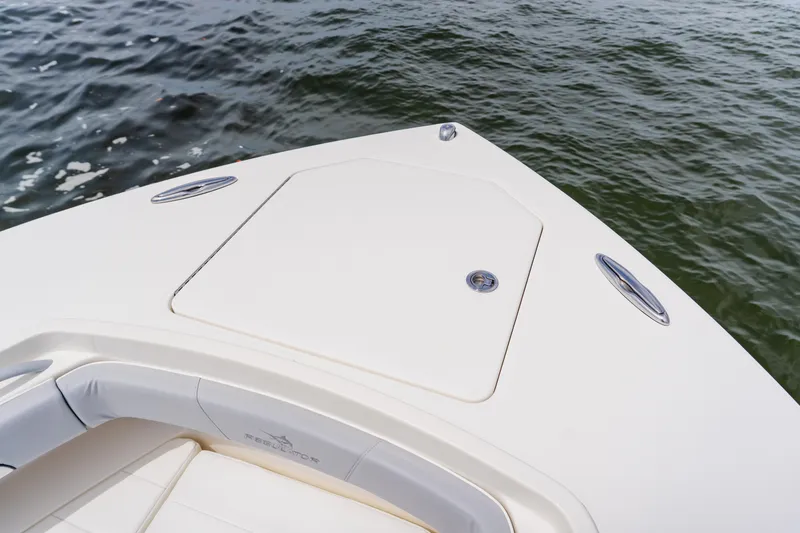 Slide: The Image of Bow of 2018 Regulator 41 boat on water, featuring sleek design and storage hatch. - 102