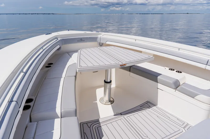 Slide: The Image of Luxurious 2018 Regulator 41 boat interior with seating and table on calm water. - 106