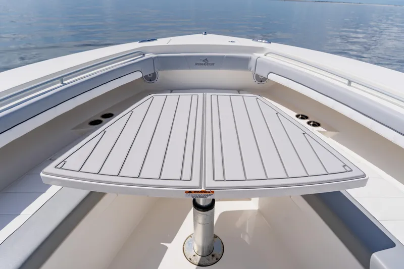 Slide: The Image of 2018 Regulator 41 boat with spacious deck and seating area on calm water. - 107