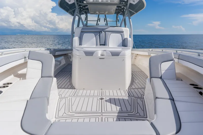 Slide: The Image of 2018 Regulator 41 boat interior with spacious seating, ocean backdrop, and clear skies. - 113