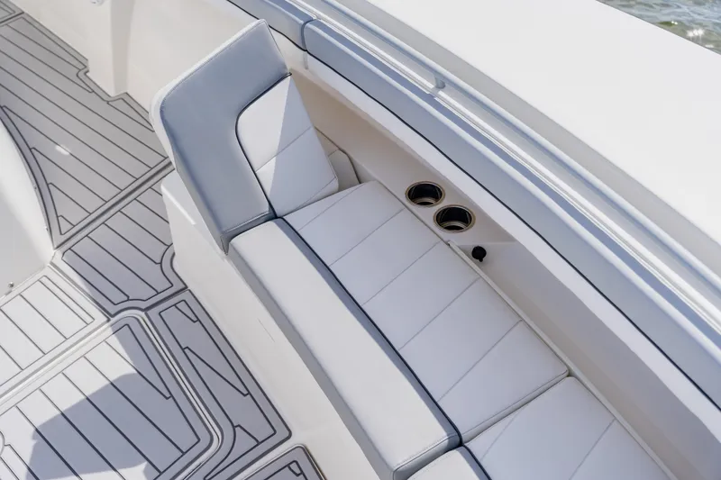 Slide: The Image of 2018 Regulator 41 boat interior with cushioned seating and cup holders. - 115