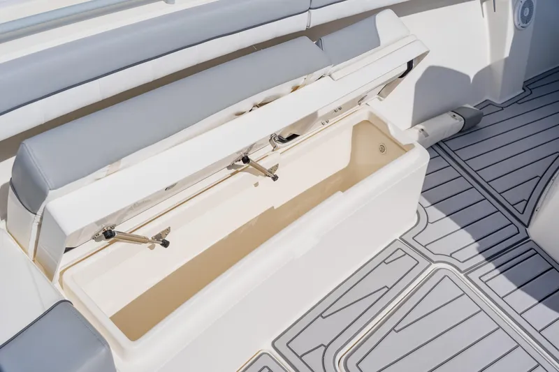 Slide: The Image of Open storage compartment on 2018 Regulator 41 boat with cushioned seating. - 119