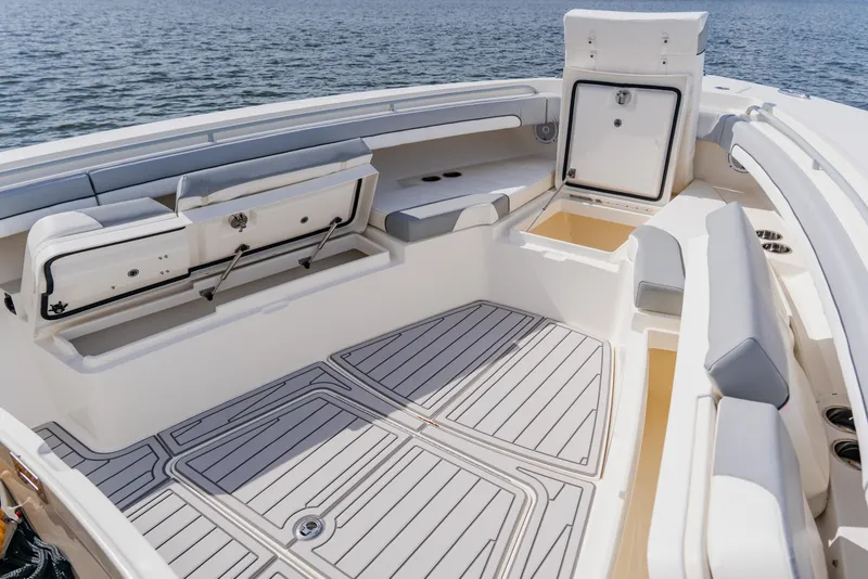 Slide: The Image of 2018 Regulator 41 boat interior with seating and storage, on calm water. - 120