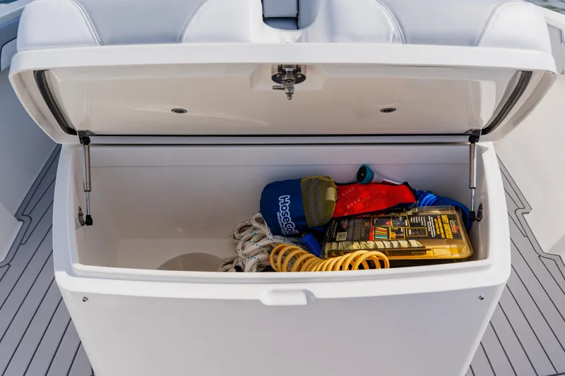 Slide: The Image of Open storage compartment on 2018 Regulator 41 boat with various boating accessories. - 123
