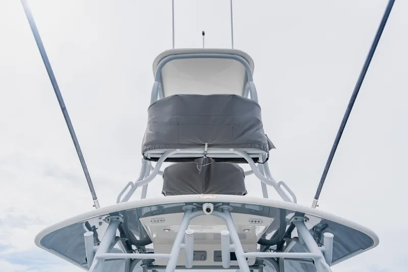 Slide: The Image of 2018 Regulator 41 boat tower with covered seating against a cloudy sky. - 130