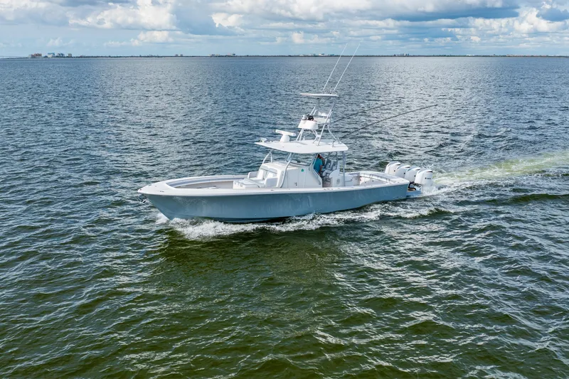 Slide: The Image of 2018 Regulator 41 boat cruising on open water under cloudy skies. - 16