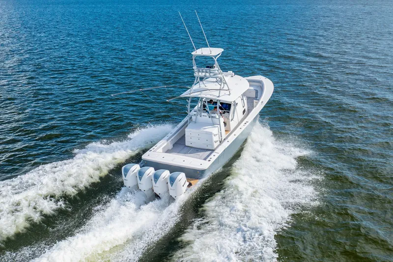 Slide: The Image of 2018 Regulator 41 boat cruising on open water, showcasing powerful engines and sleek design. - 17