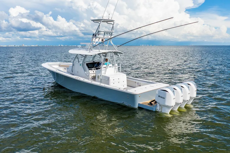 Slide: The Image of 2018 Regulator 41 boat with four Yamaha engines on open water under cloudy sky. - 2