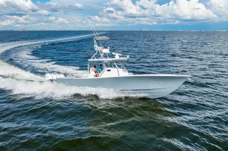 Slide: The Image of 2018 Regulator 41 boat cruising on open water under a partly cloudy sky. - 21