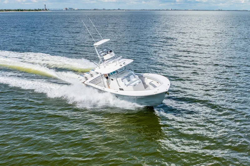 Slide: The Image of 2018 Regulator 41 boat cruising on open water, creating a dynamic wake. - 24