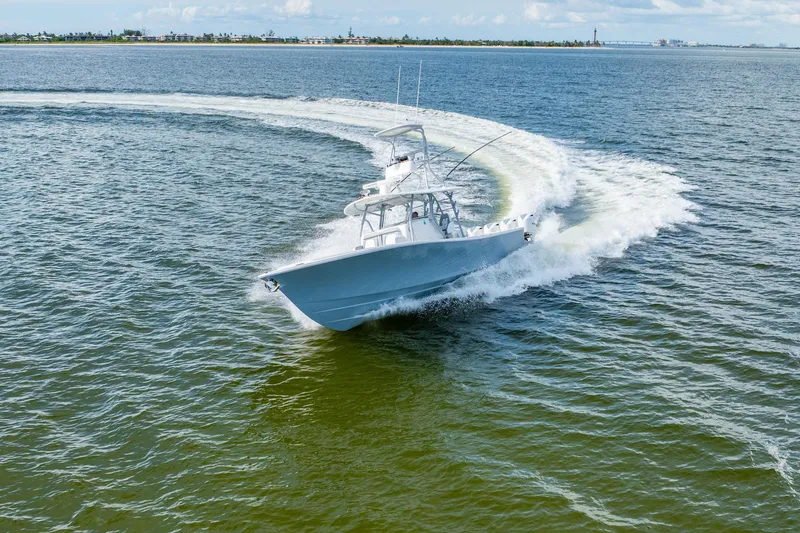 Slide: The Image of 2018 Regulator 41 boat making a sharp turn on open water. - 25