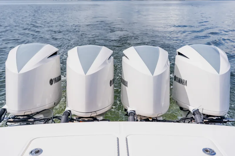 Slide: The Image of Four Yamaha outboard engines on a 2018 Regulator 41 boat, cruising on water. - 28