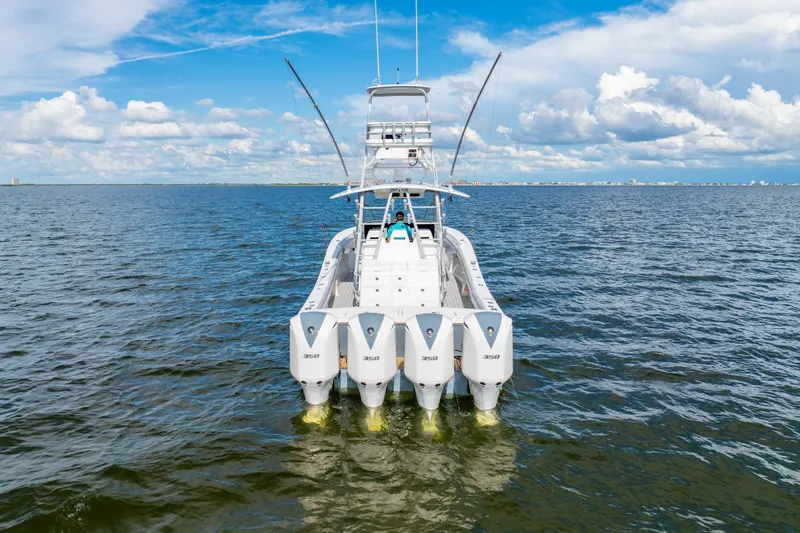 Slide: The Image of 2018 Regulator 41 boat with four powerful engines on open water under a blue sky. - 3