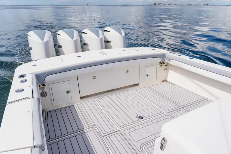 Slide: The Image of 2018 Regulator 41 boat deck with four Yamaha outboard engines on calm water. - 31
