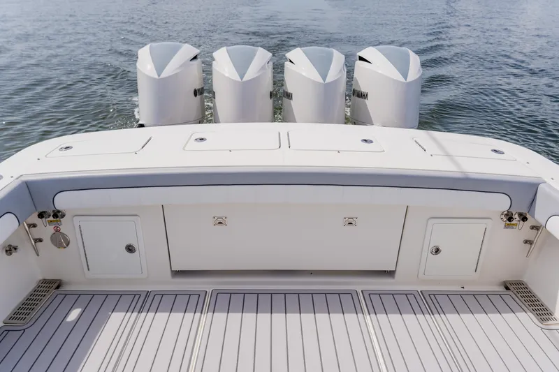 Slide: The Image of 2018 Regulator 41 boat with four Yamaha outboard engines on calm water. - 32