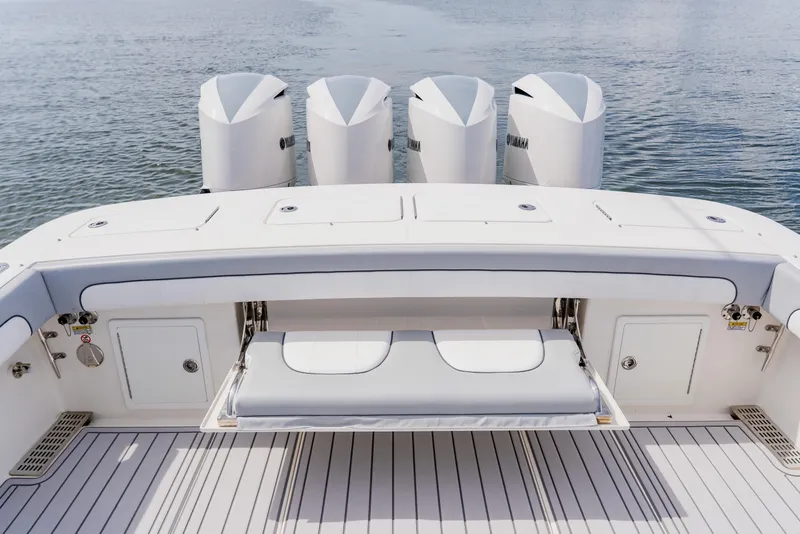 Slide: The Image of 2018 Regulator 41 boat with four powerful outboard engines on calm water. - 34