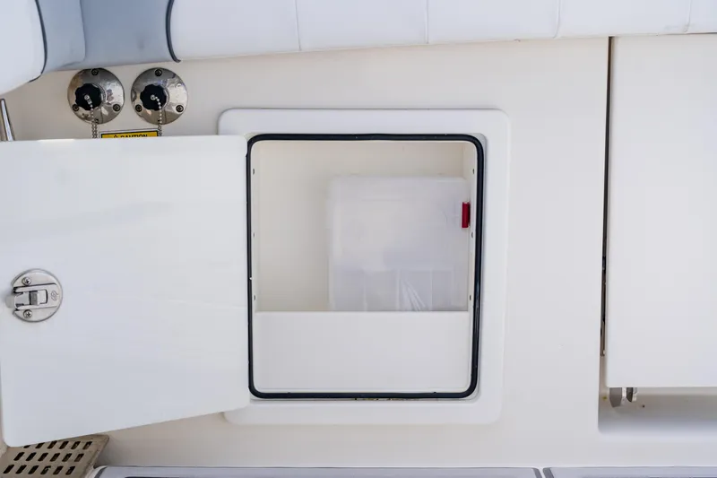 Slide: The Image of Open storage compartment on 2018 Regulator 41 boat, featuring secure latch and clean design. - 37