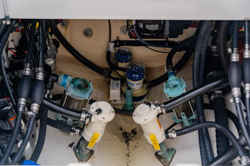 Slide: The Image of Engine compartment of a 2018 Regulator 41 boat, showcasing pumps and hoses. - 45