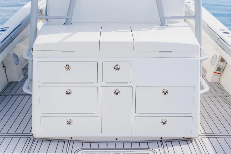 Slide: The Image of 2018 Regulator 41 boat with white storage drawers on deck. - 48