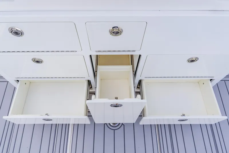 Slide: The Image of Open storage drawers on a 2018 Regulator 41 boat, showcasing ample space and sleek design. - 49