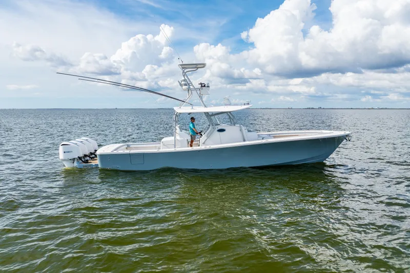 Slide: The Image of 2018 Regulator 41 boat on open water under a cloudy sky. - 5
