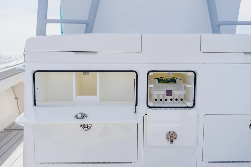 Slide: The Image of 2018 Regulator 41 boat storage compartments with open hatches, showcasing interior organization. - 51