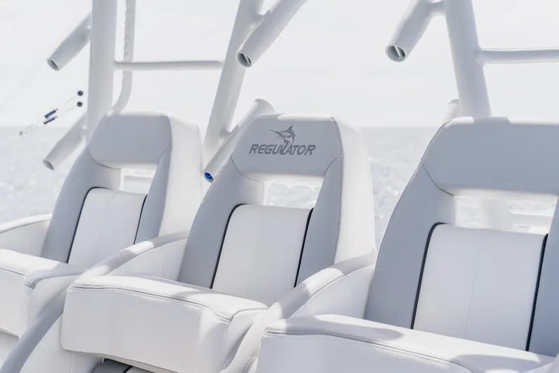 Slide: The Image of Luxury seating on 2018 Regulator 41 boat, featuring sleek white design and logo. - 56