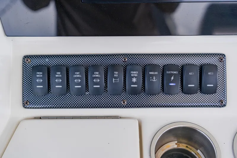 Slide: The Image of Control panel of a 2018 Regulator 41 boat with labeled switches. - 61