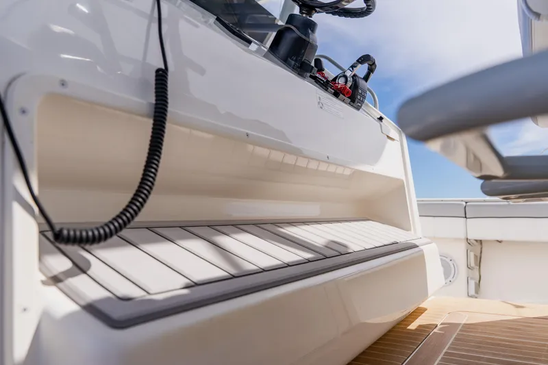 Slide: The Image of 2018 Regulator 41 boat interior with storage compartment and control panel. - 68