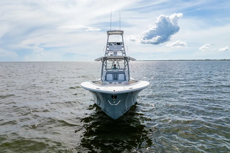 Slide: The Image of 2018 Regulator 41 boat on open water under a partly cloudy sky. - 7