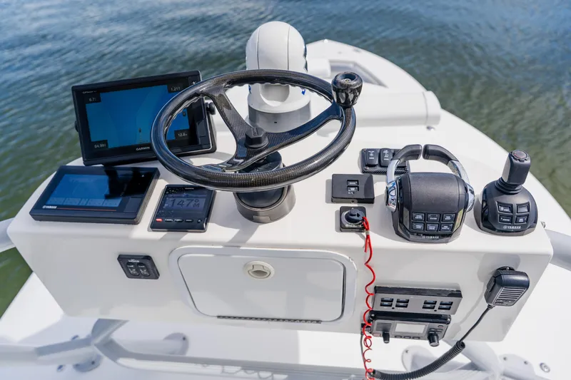 Slide: The Image of Control panel of a 2018 Regulator 41 boat with advanced navigation equipment. - 73