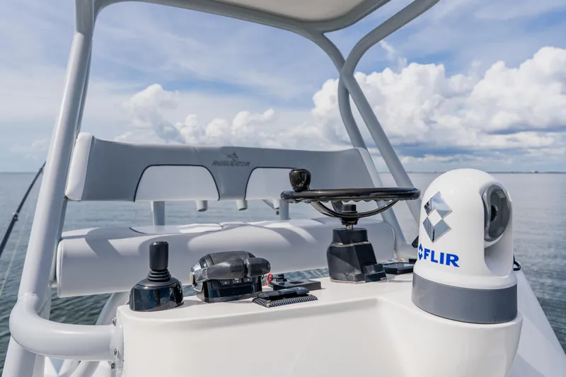 Slide: The Image of 2018 Regulator 41 boat helm with FLIR system, ocean view, and clear sky. - 77